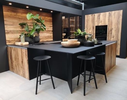Une cuisine moderne noire et bois avec comptoir 