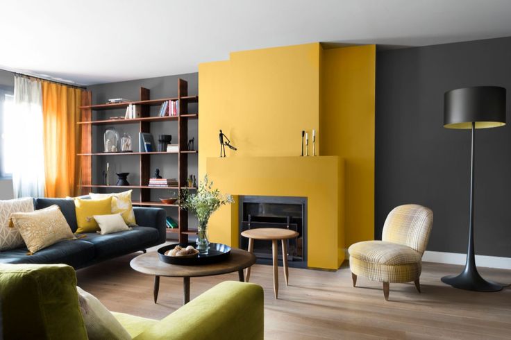 Salon raffiné avec un mur et une cheminée jaune